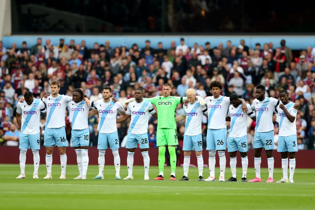 Crystal Palace players observe a minutes silence before the game