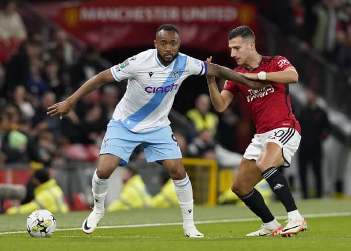 Man United vs Crystal Palace: Jordan Ayew of Crystal Palace holds off Diogo Dalot of Manchester United during the Carabao Cup match