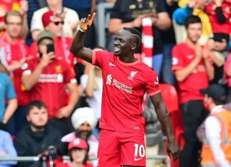 Mané makes history as Liverpool goes top